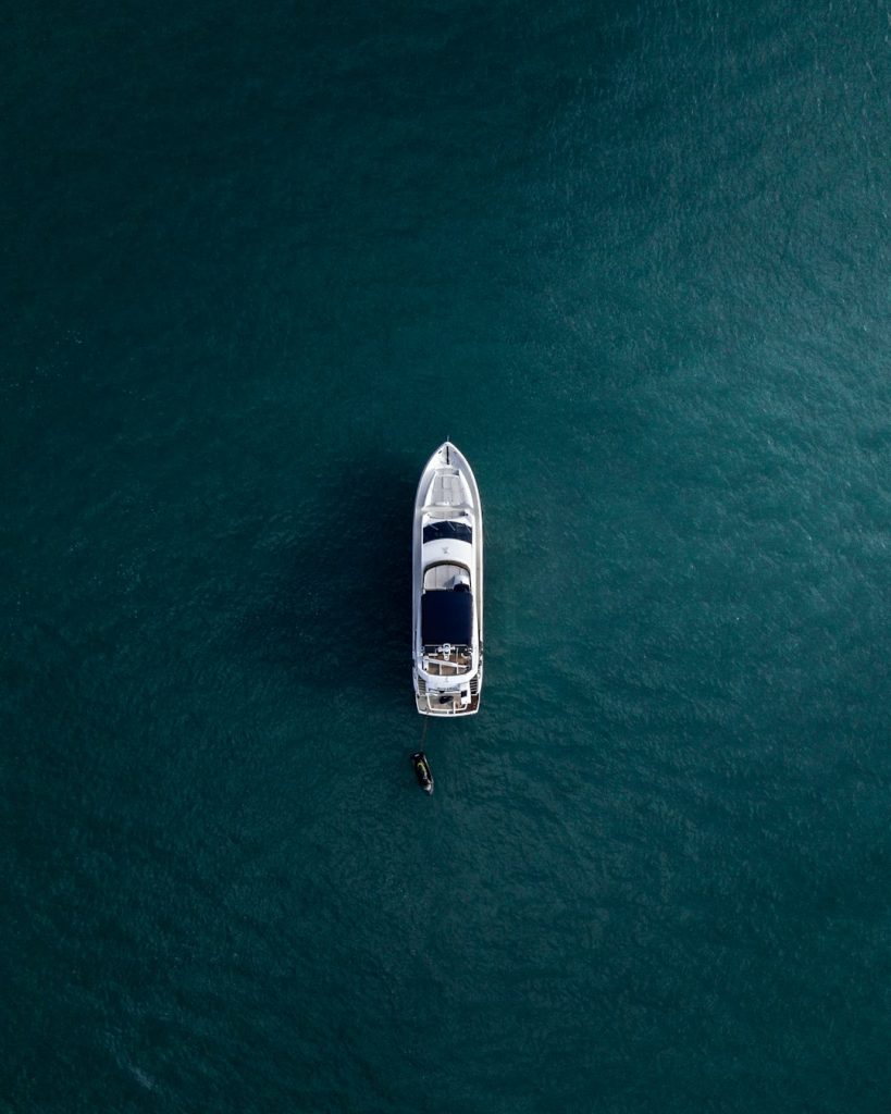 aerial-photography-of-white-yacht-on-calm-waters-t-6gw8t6jsc