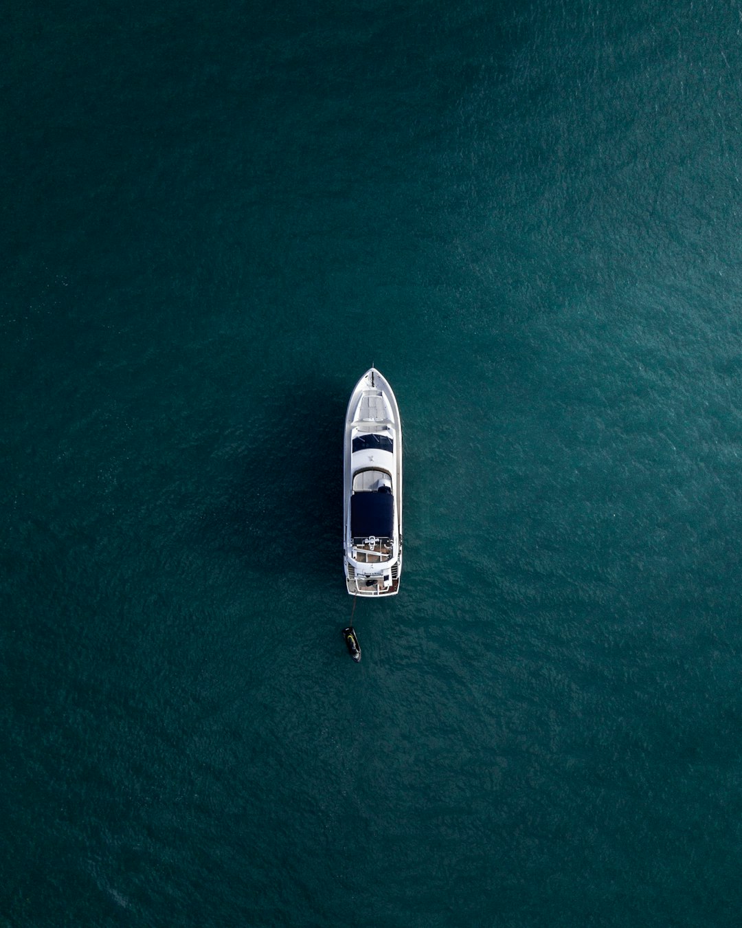 aerial-photography-of-white-yacht-on-calm-waters-t-6gw8t6jsc